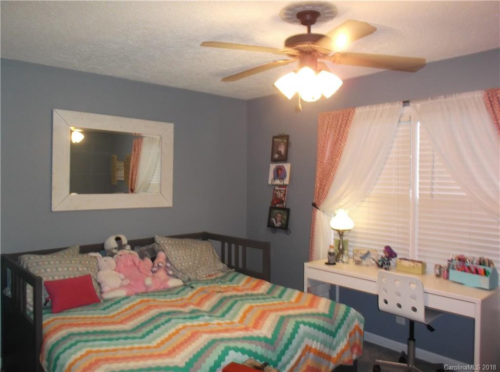 136 Maple Ridge Circle Salisbury, NC 28147 - Photo 7 of 23 a bedroom with a bed and a chandelier