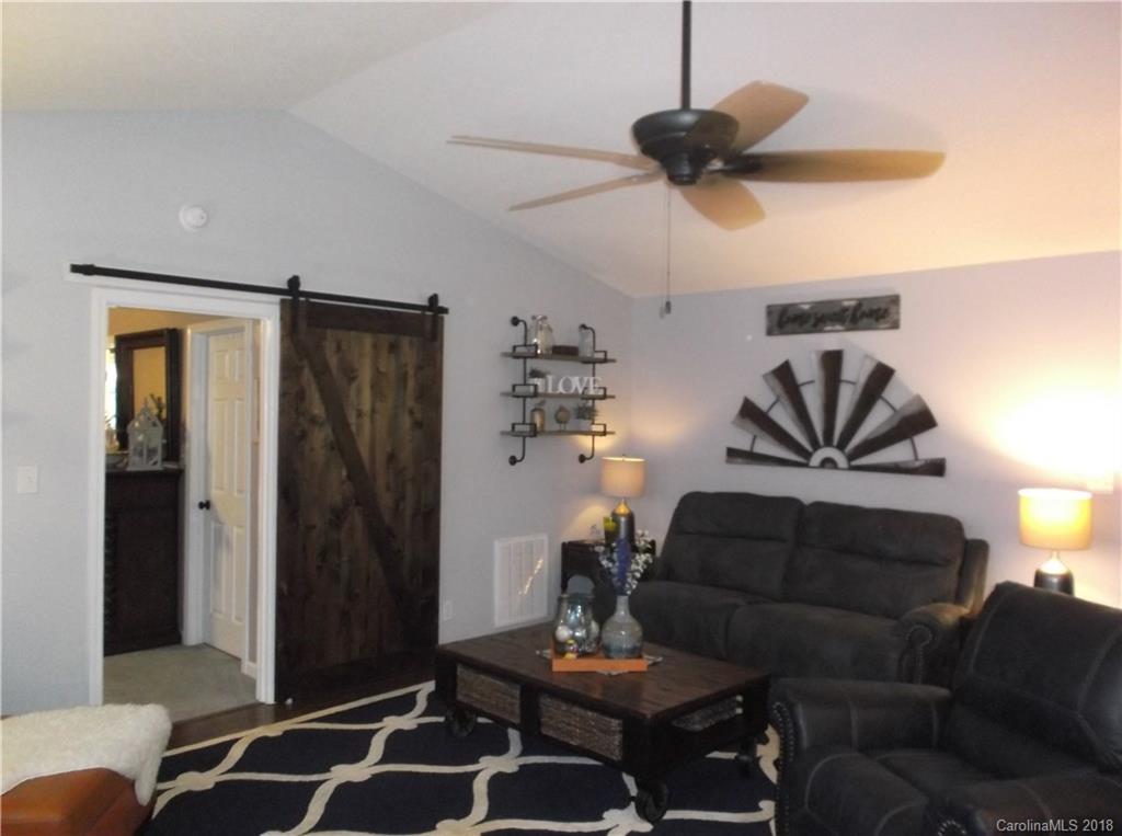 136 Maple Ridge Circle Salisbury, NC 28147 - Photo 10 of 23 a living room with furniture and a chandelier