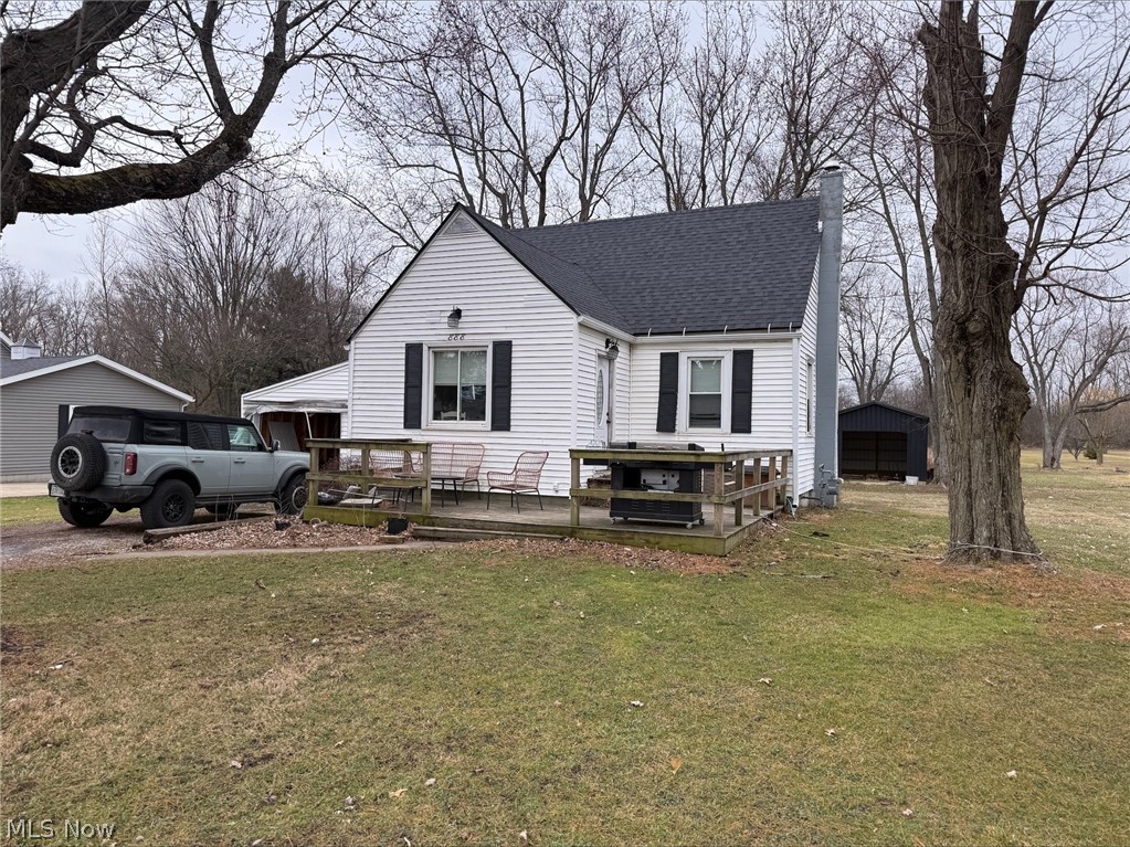 888 Beal Road Mansfield, OH 44905 - Photo 3 of 5 View of front of home featuring a wooden deck, a front lawn, a chimney, and a shingled roof