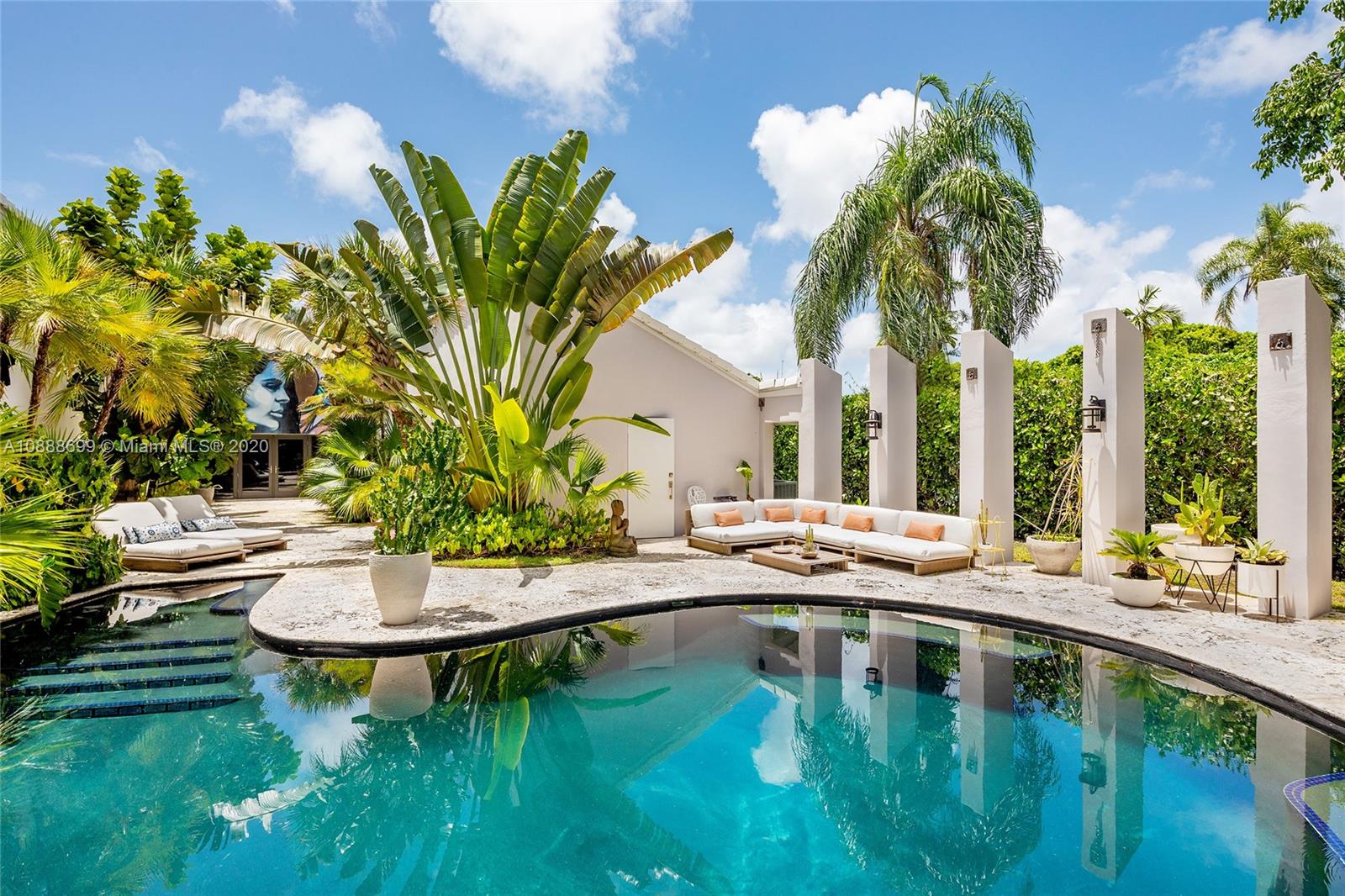 621 Island Road Miami, FL 33137 - Photo 1 of 39 a swimming pool with outdoor seating and yard