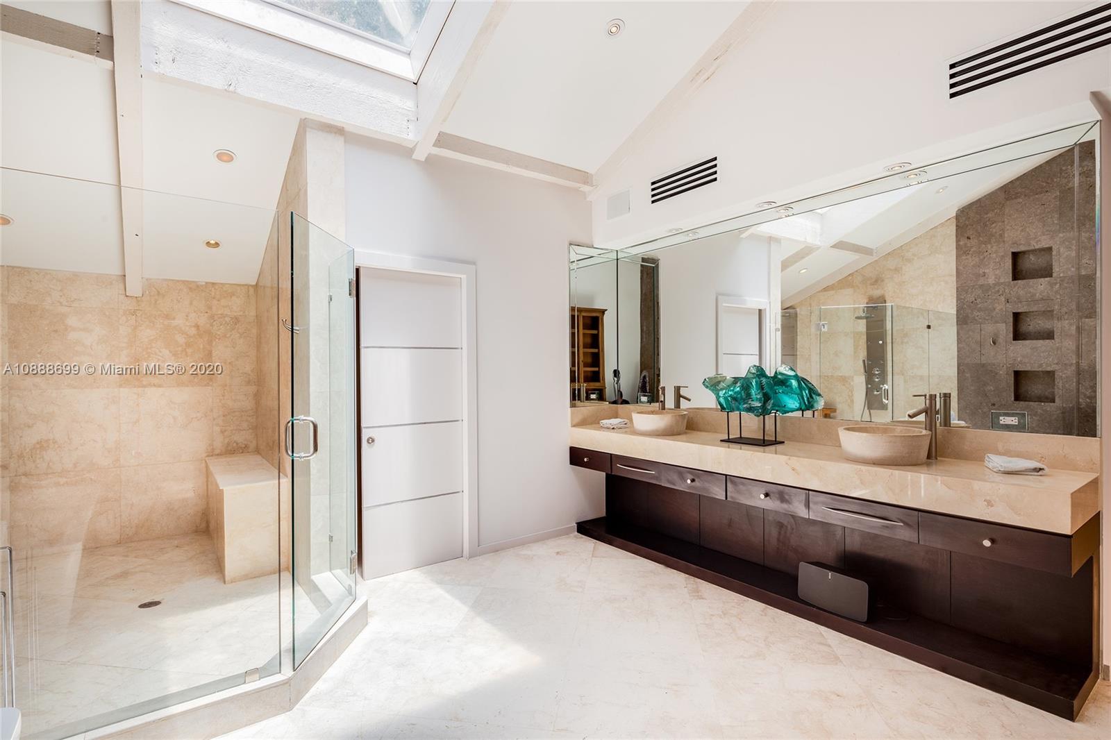 621 Island Road Miami, FL 33137 - Photo 19 of 39 a large bathroom with a double vanity sink and a mirror