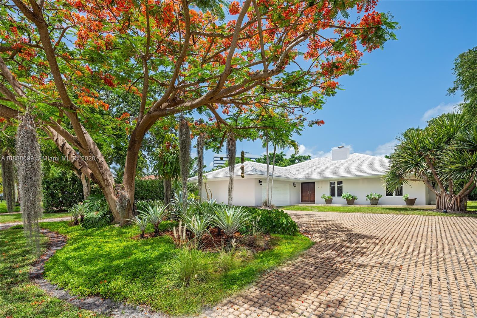621 Island Road Miami, FL 33137 - Photo 2 of 39 a view of a patio with table and chairs under an umbrella
