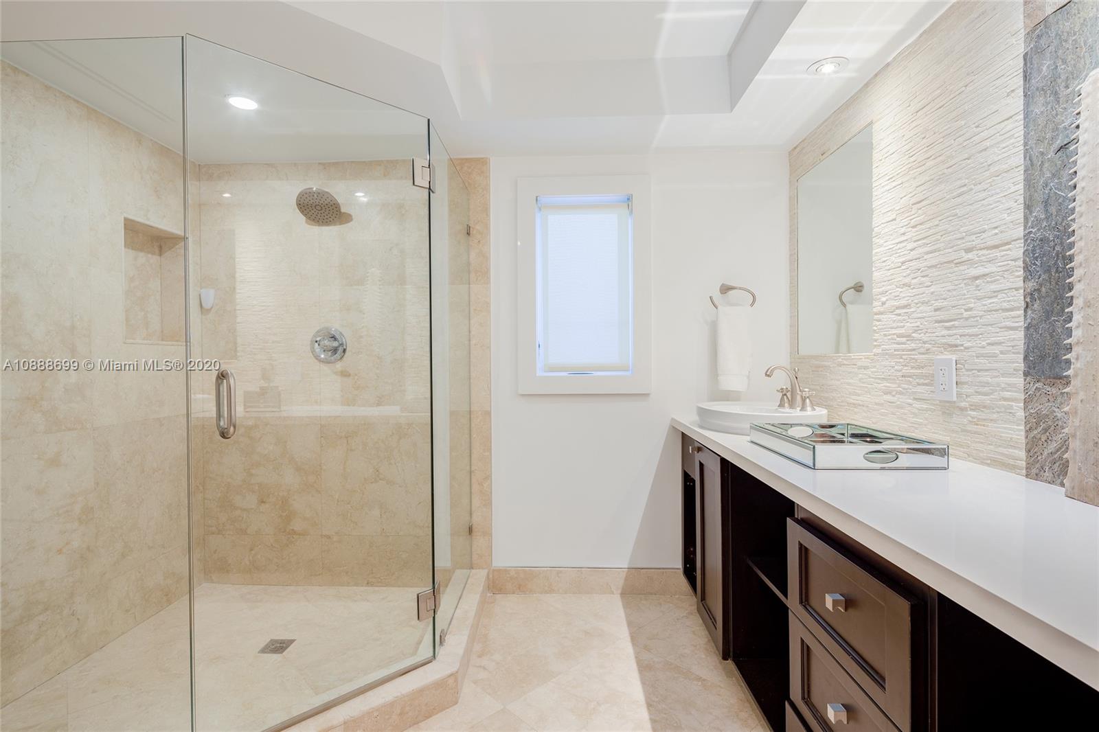 621 Island Road Miami, FL 33137 - Photo 26 of 39 a bathroom with a granite countertop sink a shower and a mirror