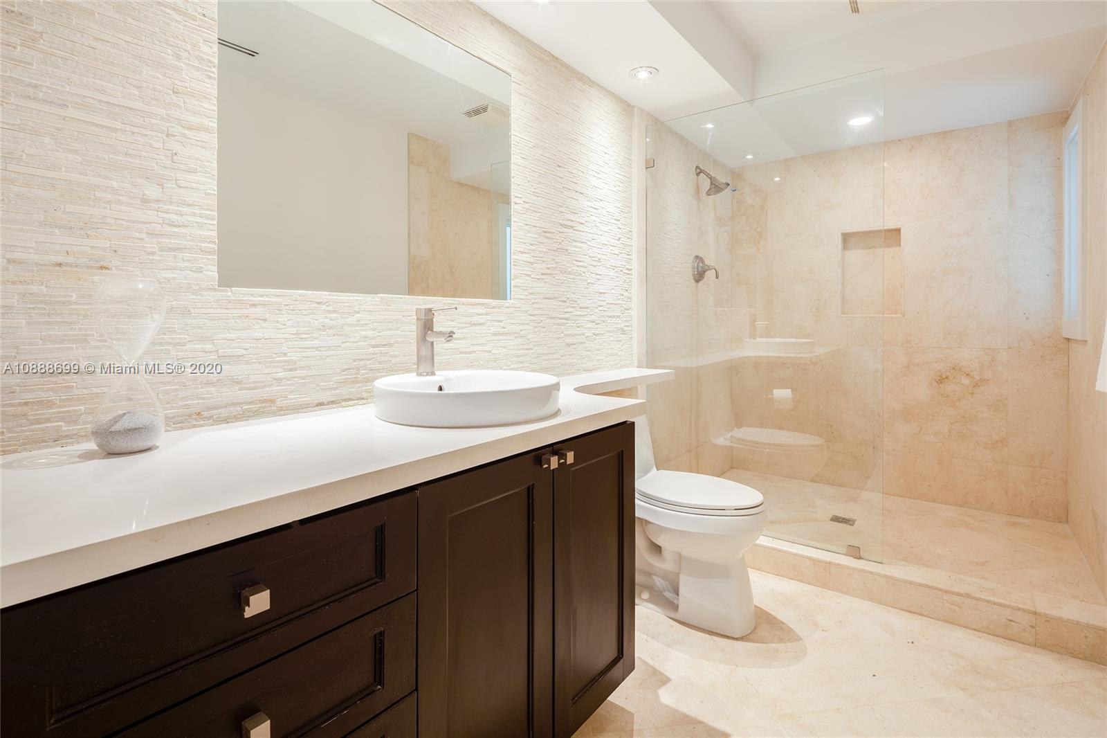 621 Island Road Miami, FL 33137 - Photo 27 of 39 a bathroom with a double vanity sink toilet and shower