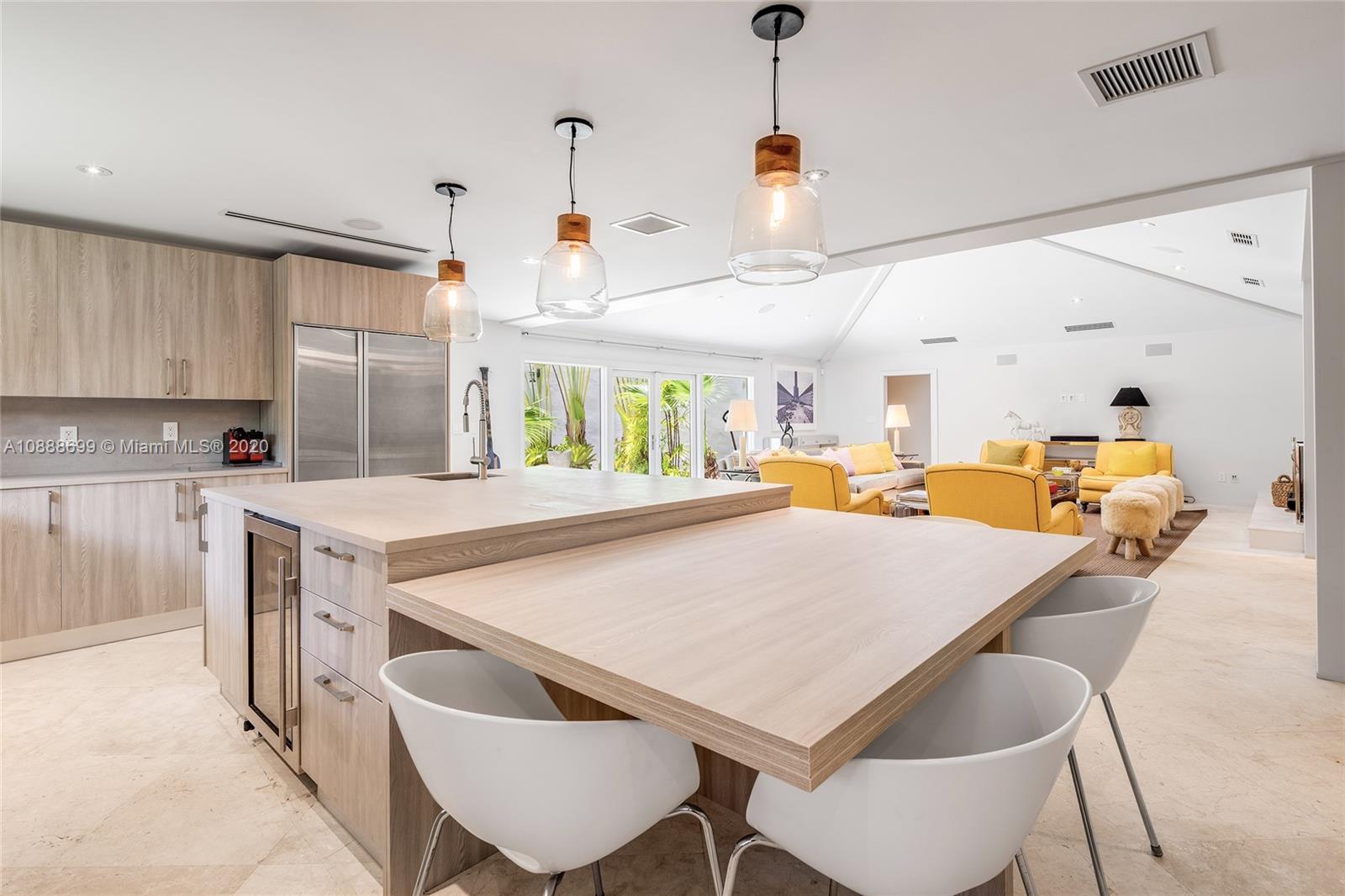 621 Island Road Miami, FL 33137 - Photo 7 of 39 a kitchen with a table chairs sink and cabinets