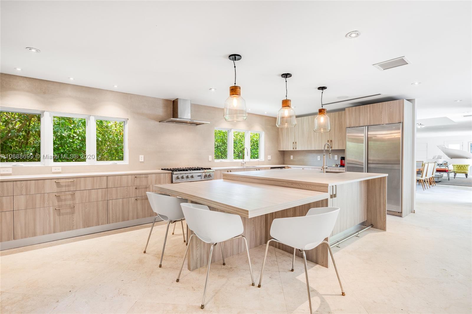 621 Island Road Miami, FL 33137 - Photo 8 of 39 a kitchen with kitchen island a table and chairs in it
