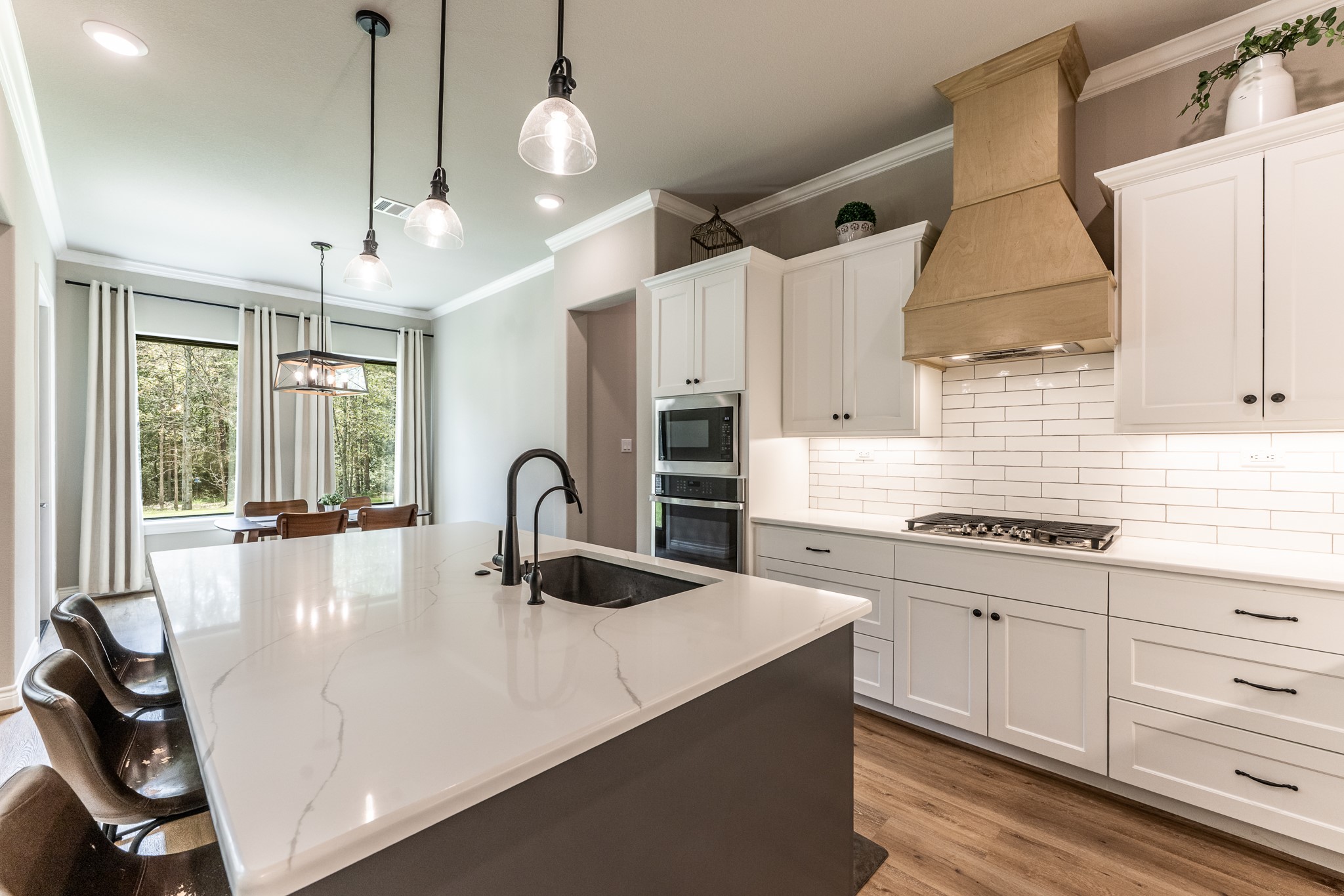 111 Eagle Run Road Willis, TX 77378 - Photo 13 of 44 Featuring a sleek Blanco granite sink, a versatile 5-burner gas cooktop, and a convenient electric wall oven and microwave.