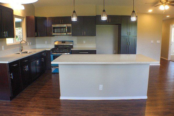 18-7857 Kaniela Road Mountain View, HI 96771 - Photo 11 of 24 a kitchen with stainless steel appliances a refrigerator and a stove