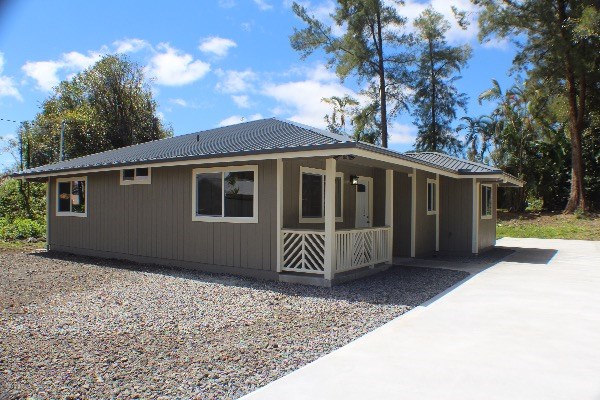 18-7857 Kaniela Road Mountain View, HI 96771 - Photo 2 of 24 a front view of a house with a garden