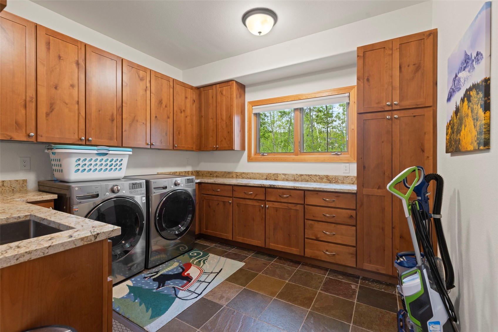 736 Wild Rose Road Silverthorne, CO 80498 - Photo 32 of 49 Laundry area with independent washer and dryer, cabinet space, and dark stone finish floors