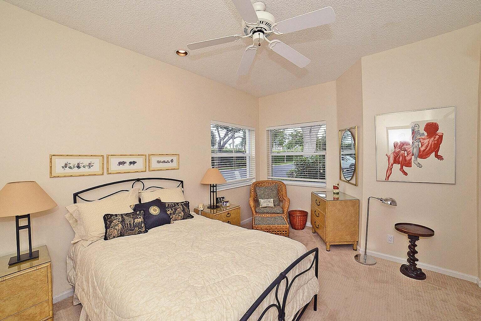 6695 Northwest 25th Court Boca Raton, FL 33496 - Photo 14 of 40 a bedroom with a bed and a chandelier
