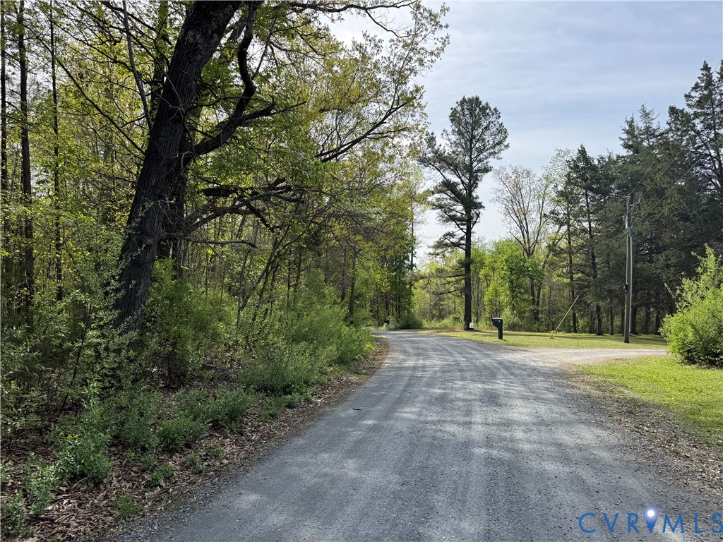 The property includes a gravel road with surroundi