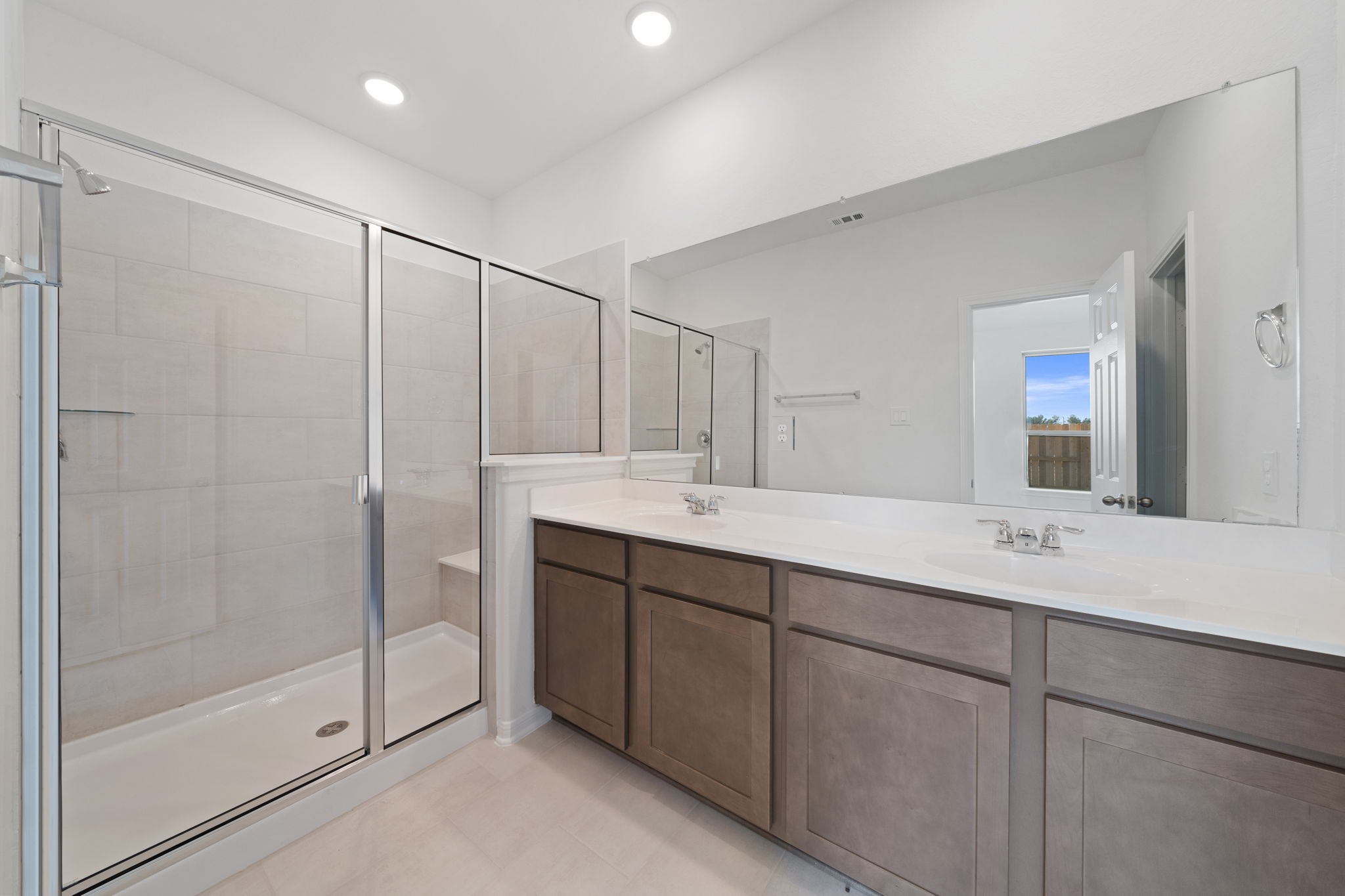 23623 Cinnamon Tree Lane Katy, TX 77493 - Photo 11 of 31 a bathroom with a shower sink and mirror