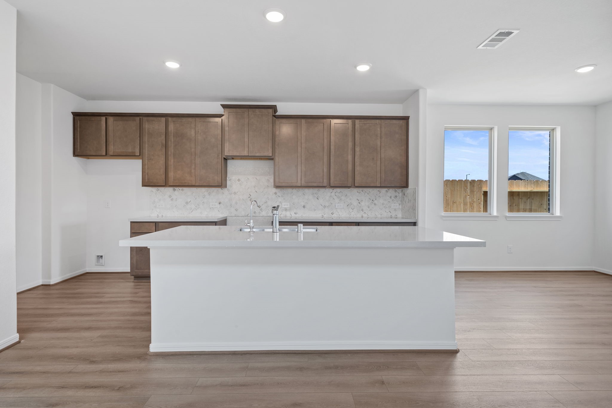 23623 Cinnamon Tree Lane Katy, TX 77493 - Photo 8 of 31 a large kitchen with stainless steel appliances granite countertop a white stove top oven and a dishwasher with wooden floor