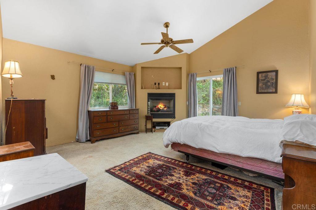 29560 Lilac Road Valley Center, CA 92082 - Photo 20 of 43 a living room with furniture flat screen tv and a fireplace