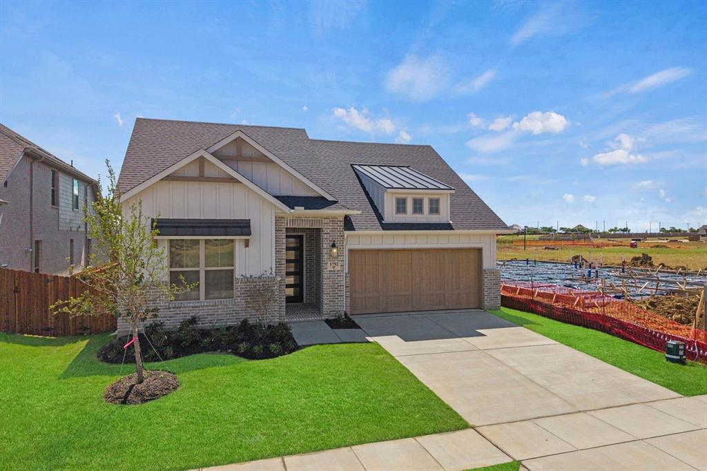 1792 Monarch Way Oak Point, TX 75068 - Photo 2 of 26 a front view of a house with a yard and garage