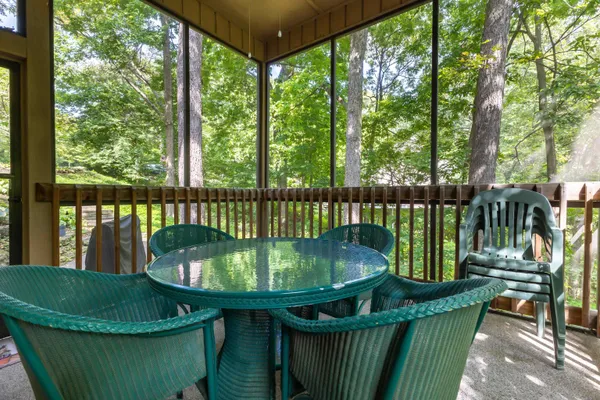 a view of a wooden deck with furniture and garden