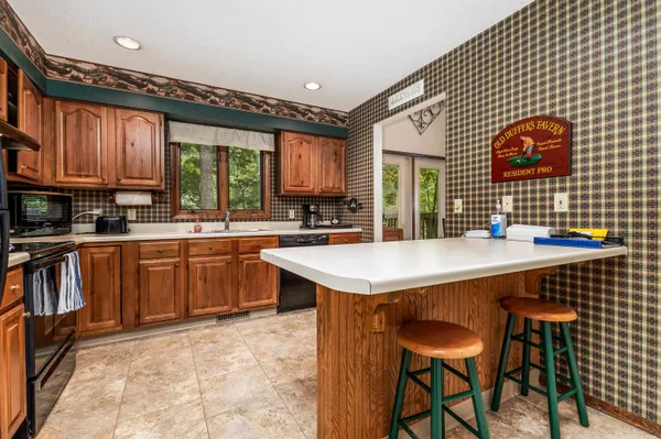 a kitchen with a sink cabinets and wooden floor