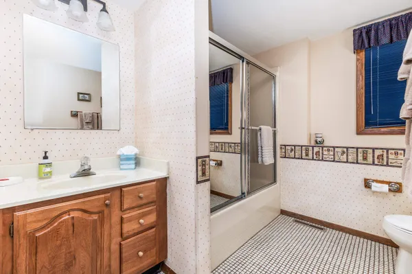 a bathroom with a sink a toilet and mirror