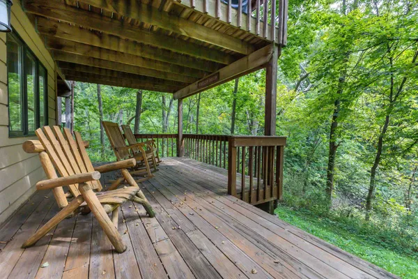 a view of deck with chairs and wooden floor