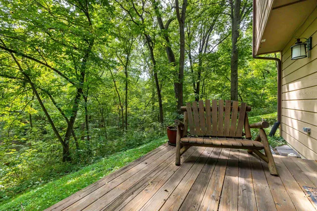 a view of backyard with a deck and wooden floor