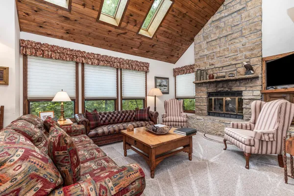a living room with fireplace furniture and a flat screen tv