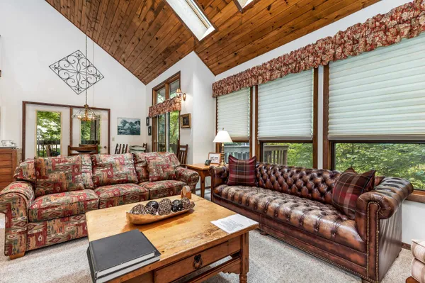 a living room with furniture and large windows