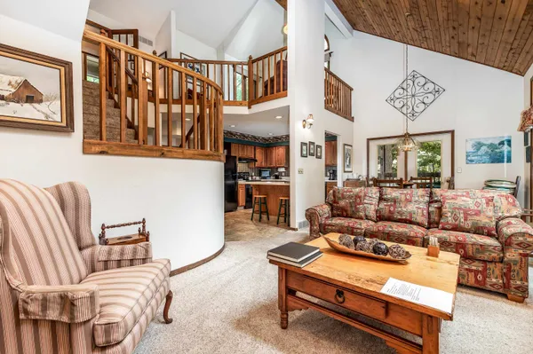a living room with furniture a couch and paintings on the wall