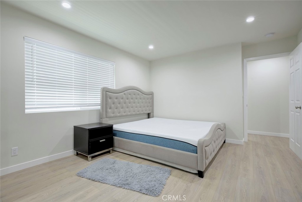 7711 Forsyth Street Tujunga, CA 91042 - Photo 13 of 35 a spacious bedroom with a bed and a window