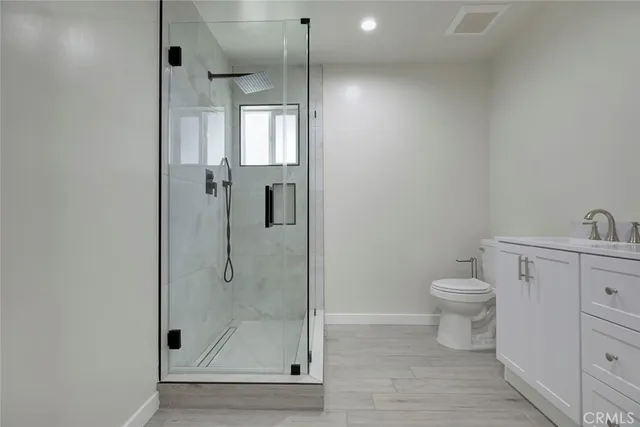 a bathroom with a shower a toilet and sink