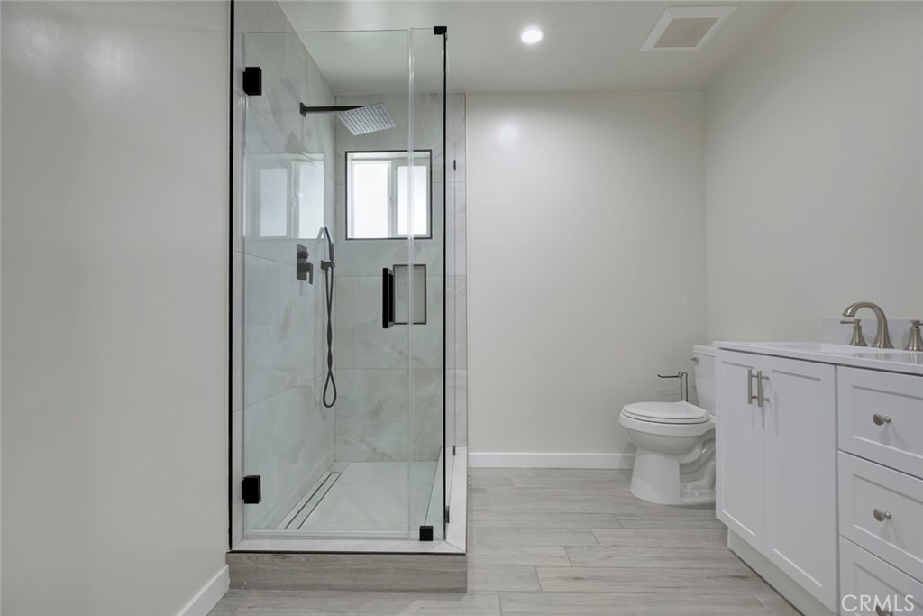7711 Forsyth Street Tujunga, CA 91042 - Photo 14 of 35 a bathroom with a shower a toilet and sink