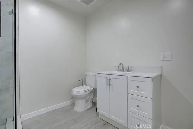 a bathroom with a sink a toilet and vanity