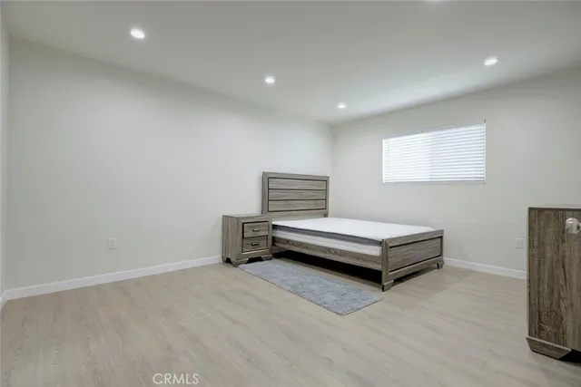 a bedroom with furniture and wooden floor