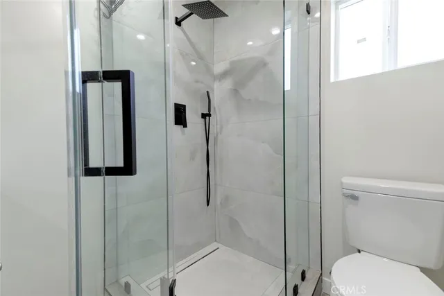 a bathroom with a shower toilet and sink