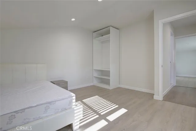a bedroom with a bed and cabinets
