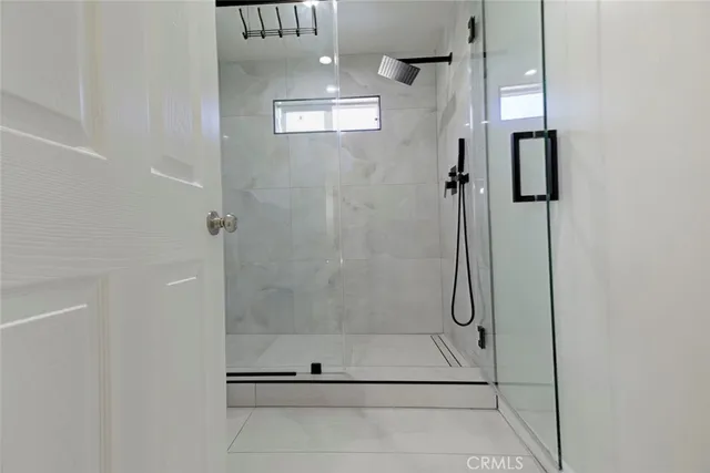 a bathroom with a glass shower door