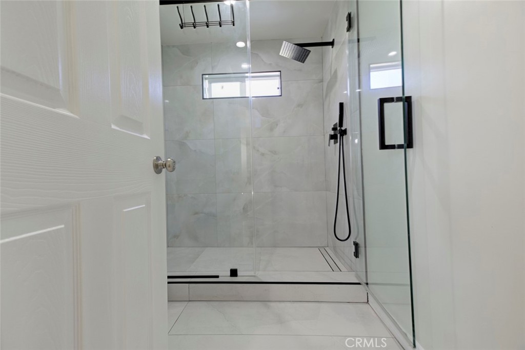 7711 Forsyth Street Tujunga, CA 91042 - Photo 26 of 35 a bathroom with a glass shower door