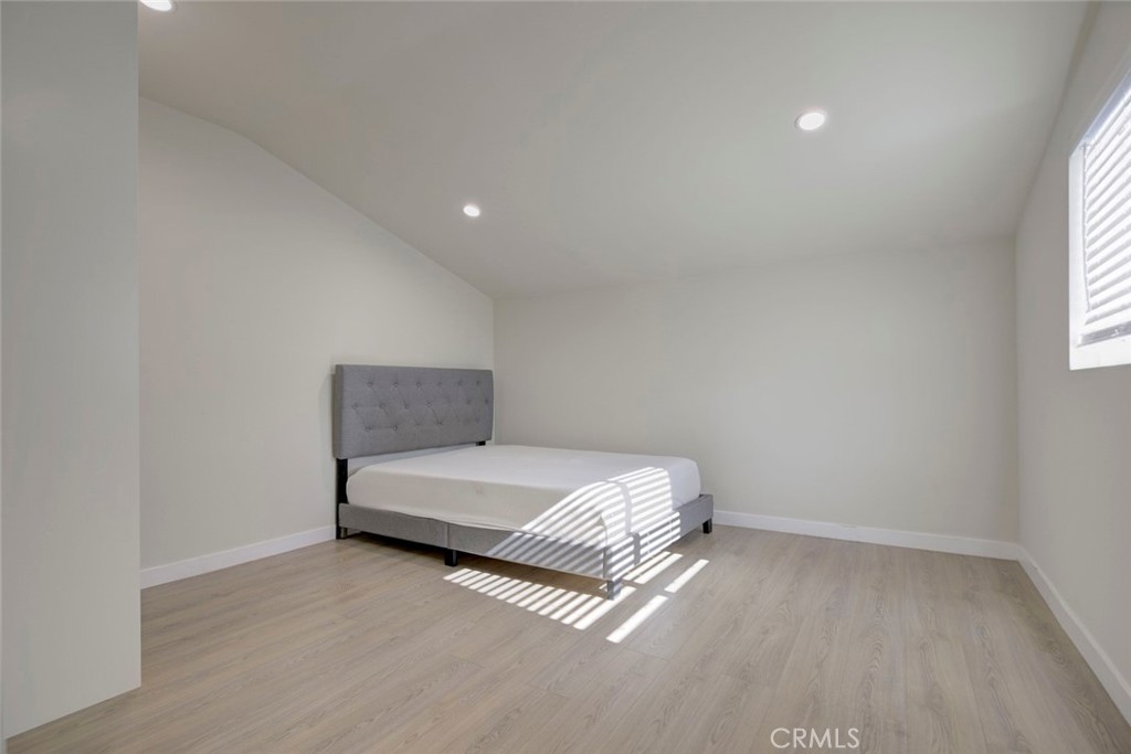 7711 Forsyth Street Tujunga, CA 91042 - Photo 28 of 35 a spacious bedroom with a bed and a window