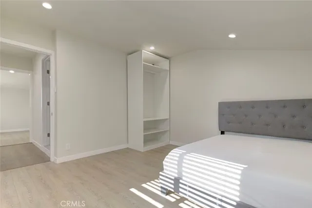 a bedroom with a bed and a walk in closet