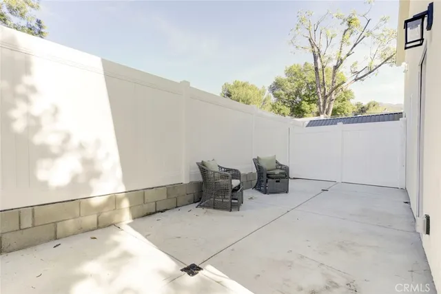 a view of a chairs and table in patio