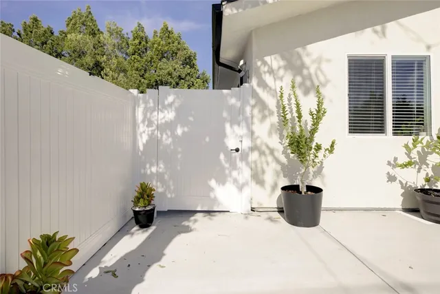 a white vase with flowers on a table