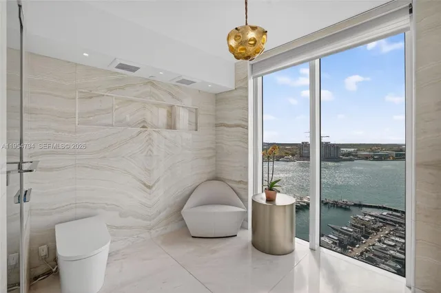 a very nice looking living room with a large window and wooden floor