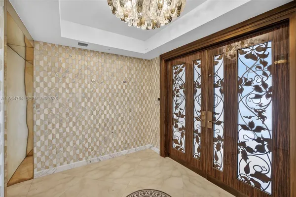 a view of a hallway view with wooden floor and a bathroom