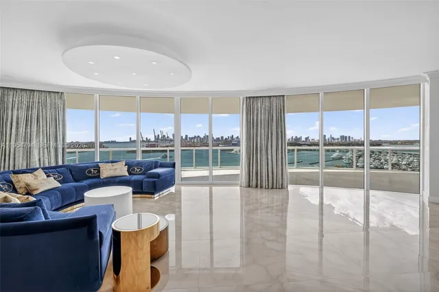 a living room with furniture and kitchen view