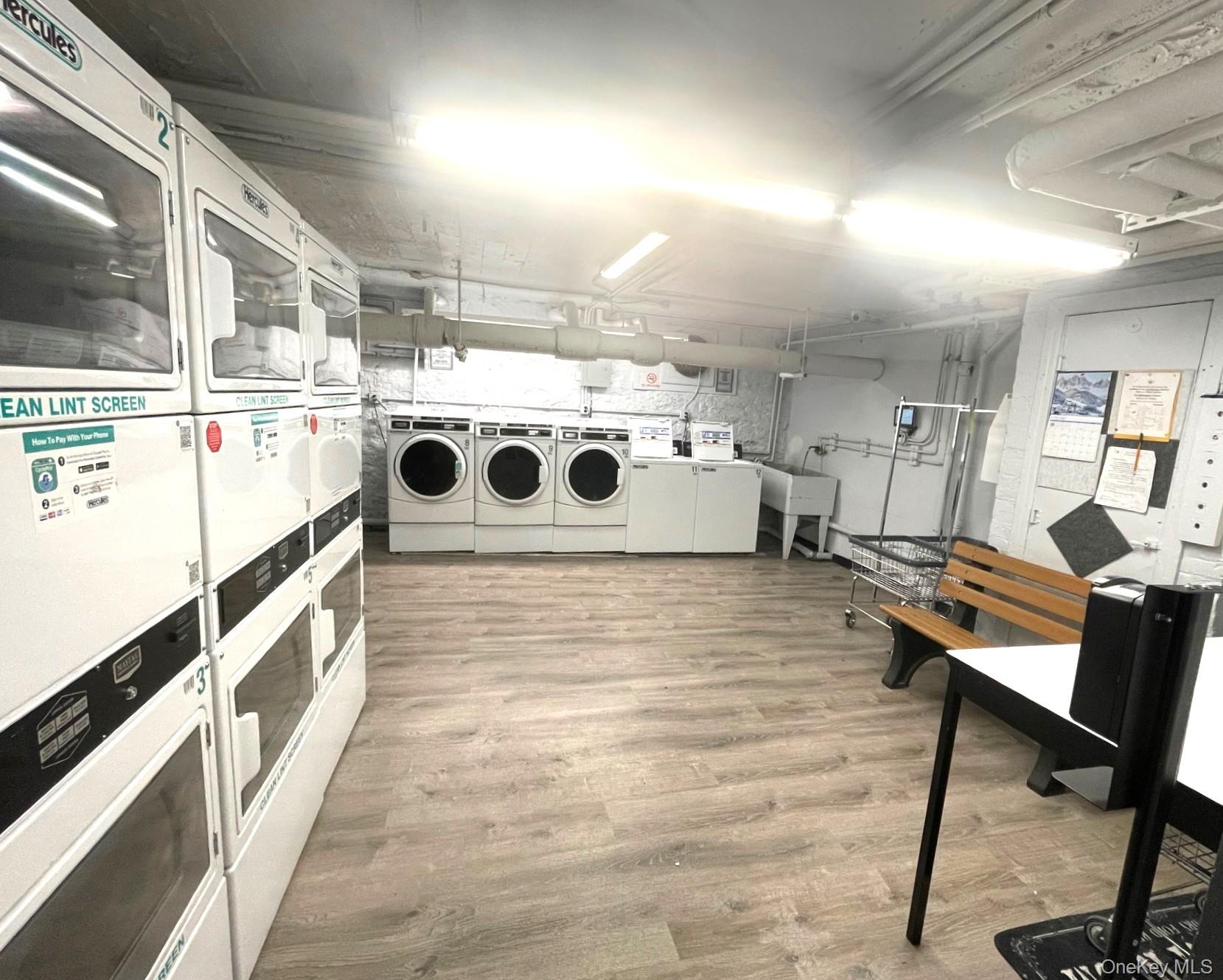 475 Bronx River Road, Unit 3G Yonkers, NY 10704 - Photo 19 of 21 a kitchen with stainless steel appliances kitchen island granite countertop a sink and wooden cabinets