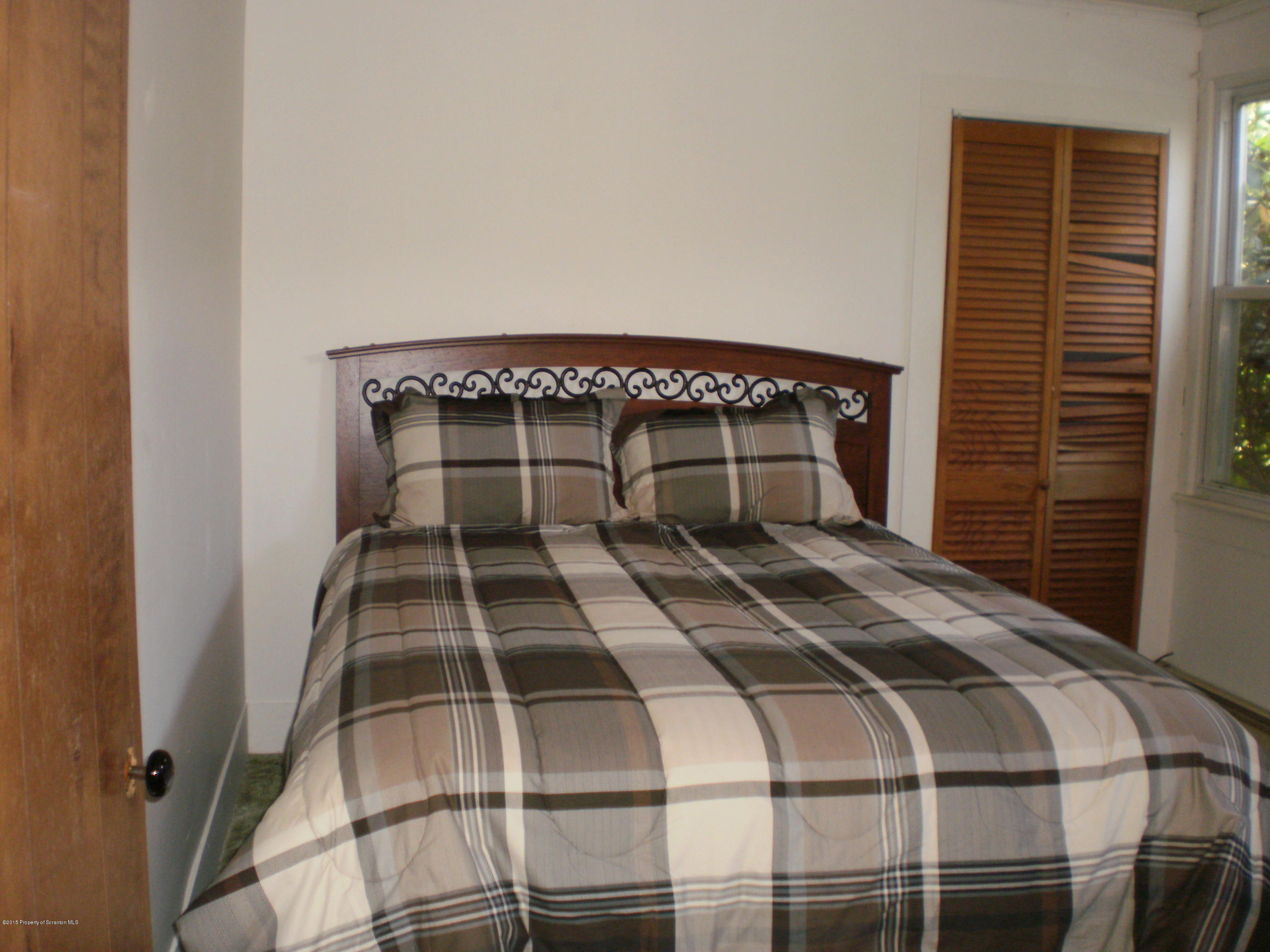 3026 West Nicholson Road Nicholson, PA 18446 - Photo 17 of 22 a bedroom with a bed and a window