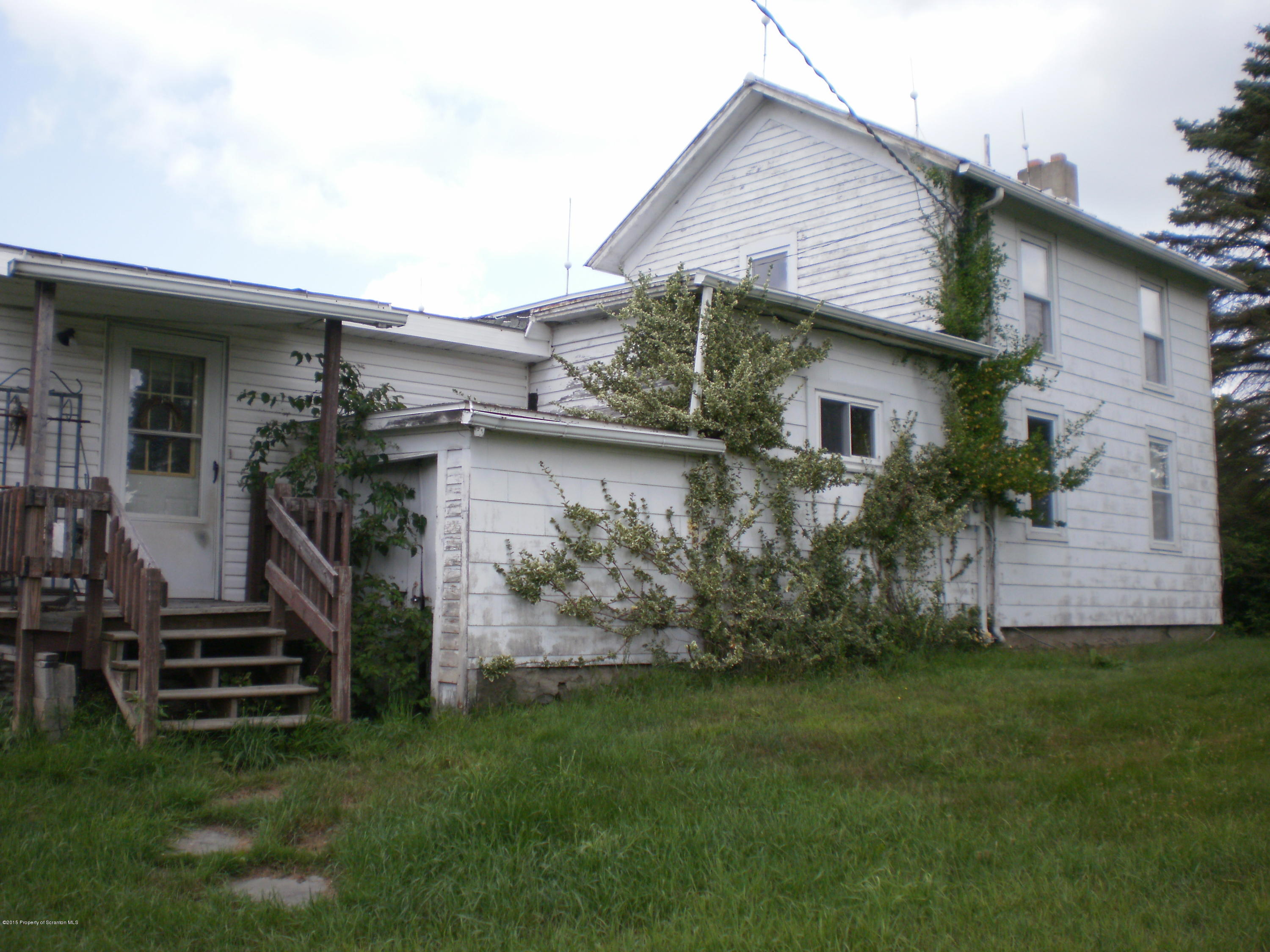 3026 West Nicholson Road Nicholson, PA 18446 - Photo 5 of 22 a front view of house with deck and garden