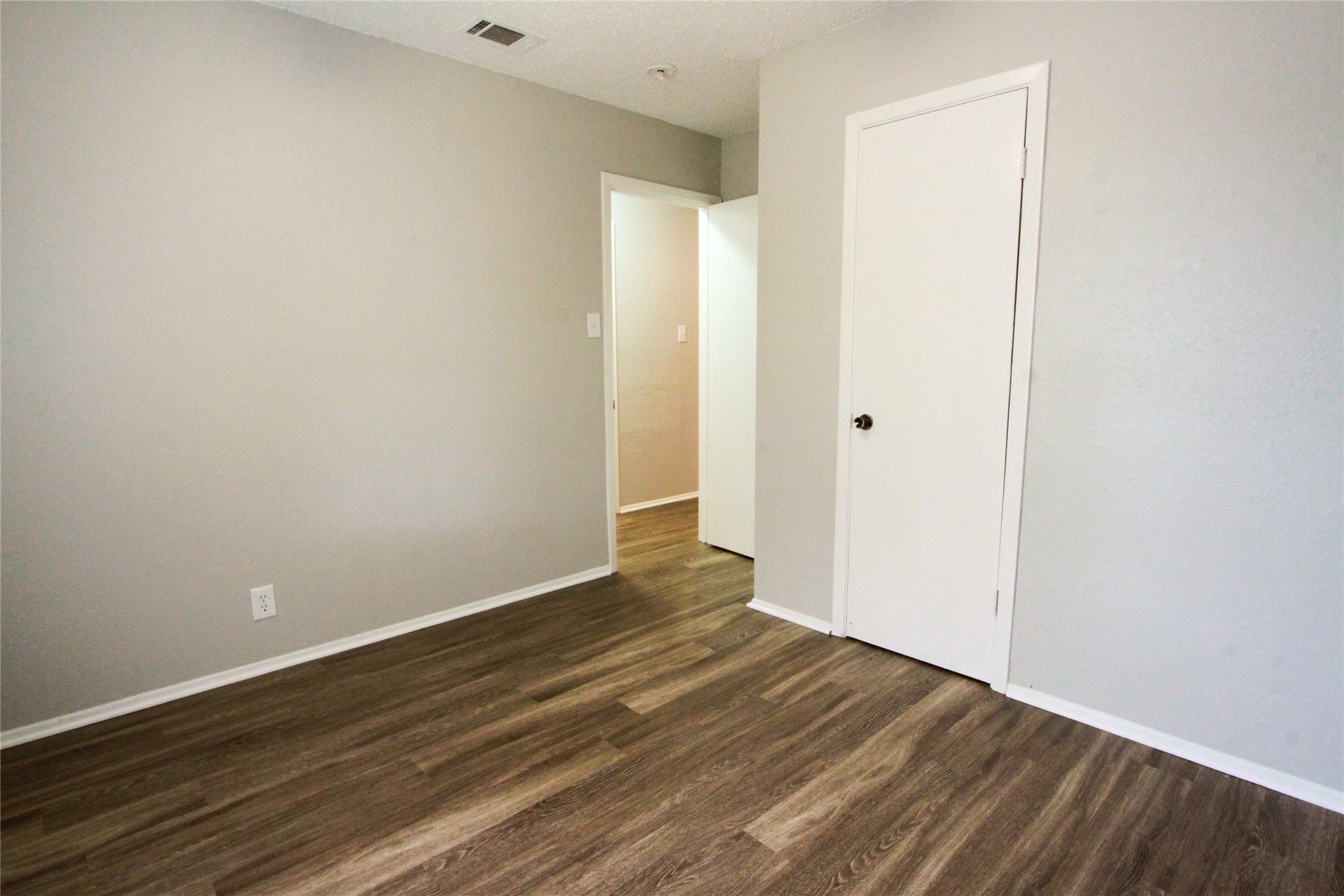 12609 Turtle Rock Road, Unit A Austin, TX 78729 - Photo 12 of 22 Smooth wood-style flooring and neutral walls define this versatile bedroom interior.