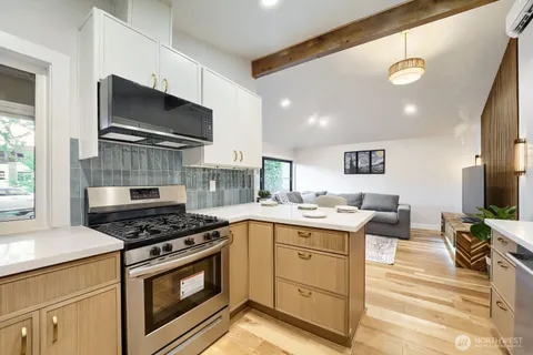 a kitchen with a sink stove and microwave