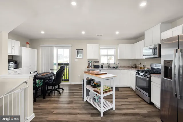 a view of kitchen with cabinets table and chairs